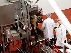 An employee filling powder into a bag